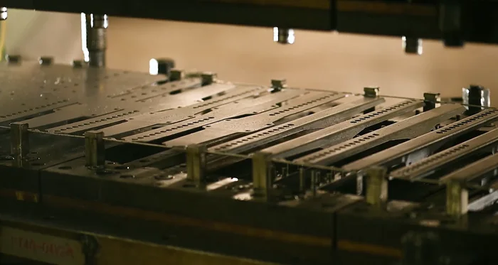 Metal bracket components in a production fixture